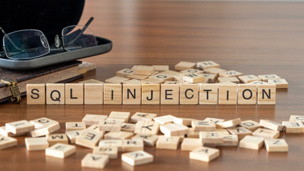 The words "SQL injection" spelled out on Scrabble letter tiles